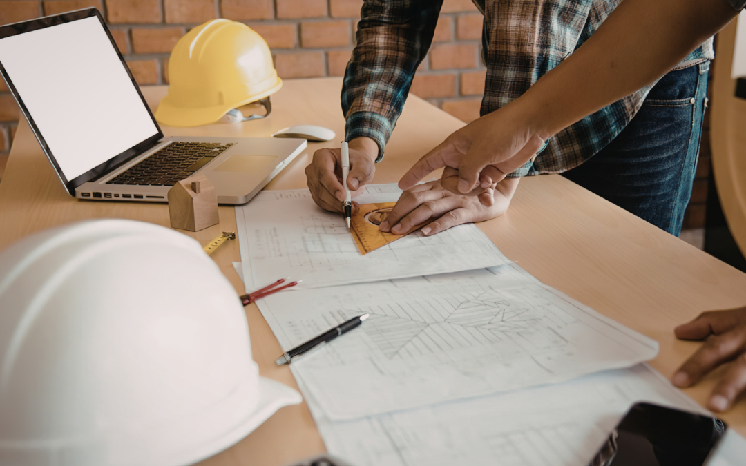 Construction company owner standing at a job site with crew and equipment, considering selling his business